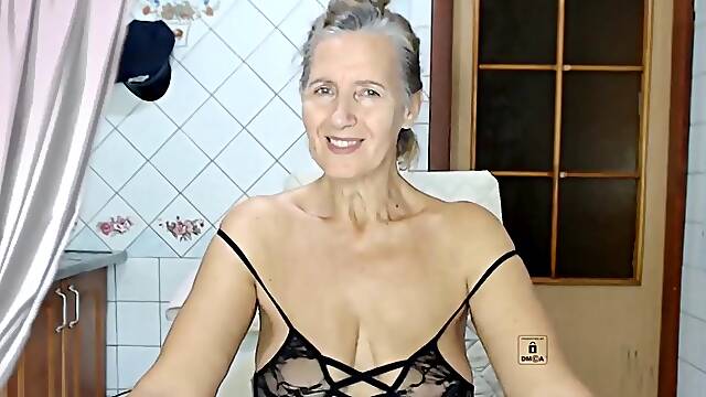 Lukerya, a steamy housewife, models lingerie and tries out various dresses